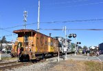 Chessie System Caboose # 904059 is on the rear of the train as it blocks the Central Avenue Grade Crossing as a healthy crowd partakes in the festivities